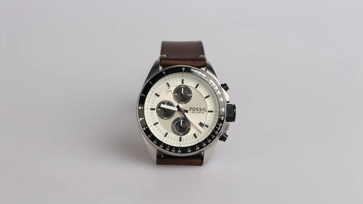 round silver-colored Fossil chronograph watch at 9:22 with brown leather band