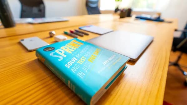 blue and green book on brown wooden table