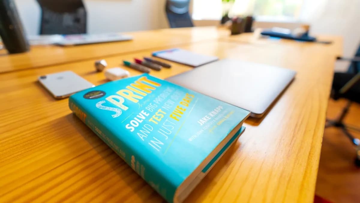 blue and green book on brown wooden table