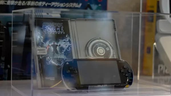 A psp and its game inside a display case.