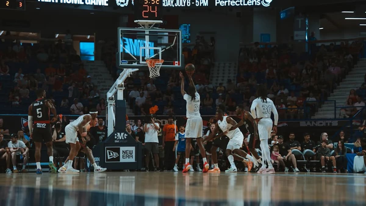 A basketball player shoots the ball during a game.