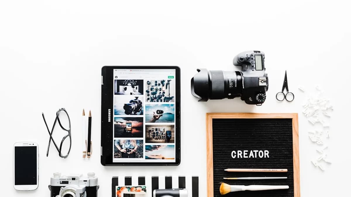 flat view of cameras beside computer tablet and smartphone