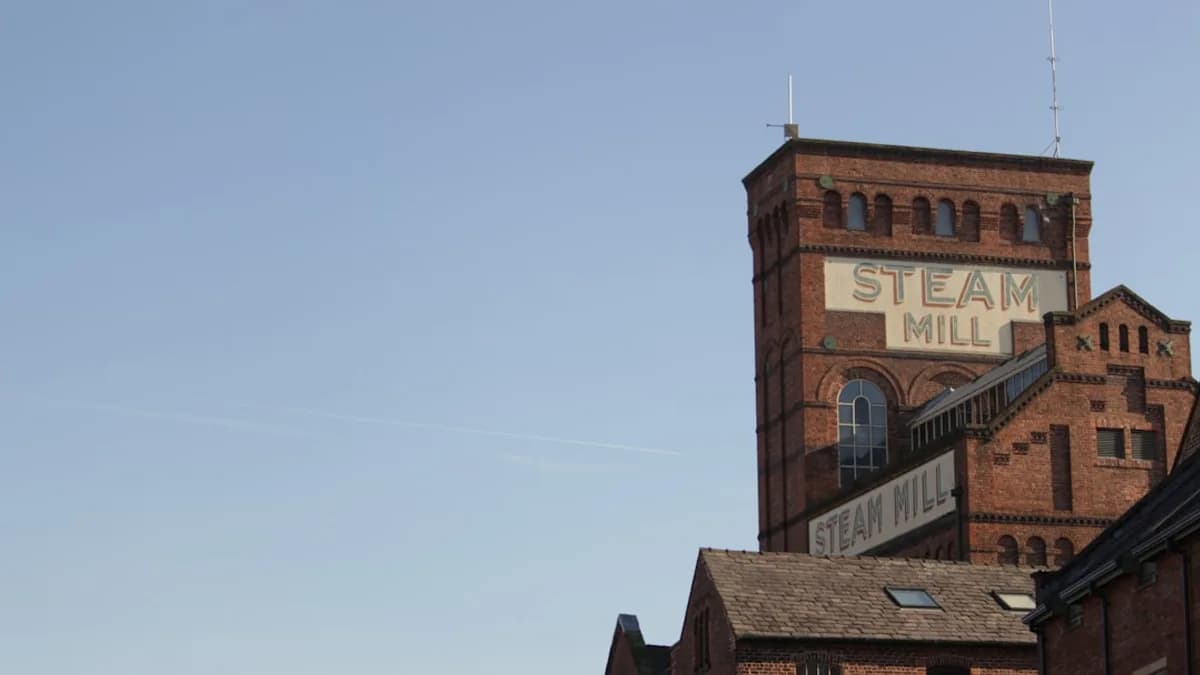 a tall brick building with a steeple on top