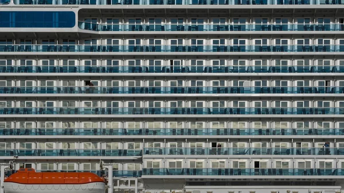 Close-up of a large cruise ship with many balconies.