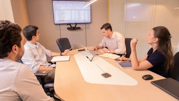 Business meeting with people around a conference table.