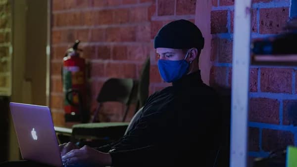 man in black jacket wearing blue goggles