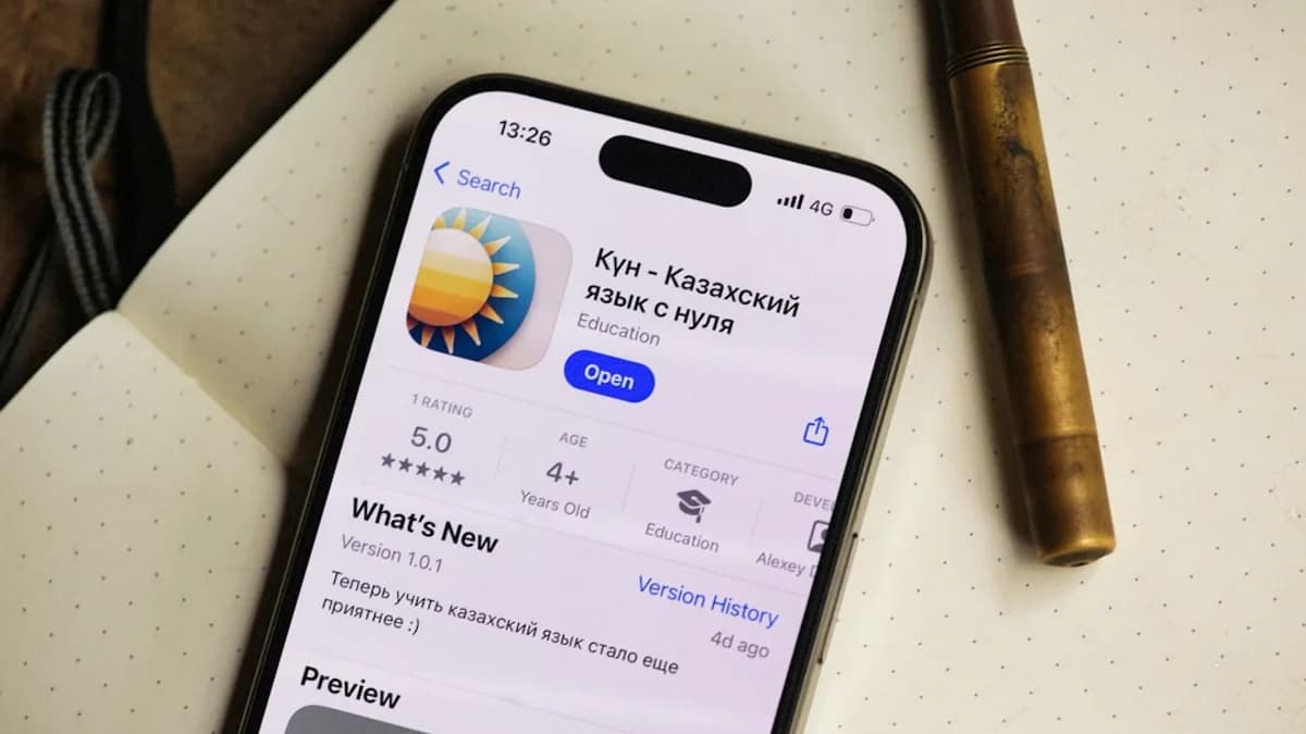 An iPhone shows a kazakh language learning app.