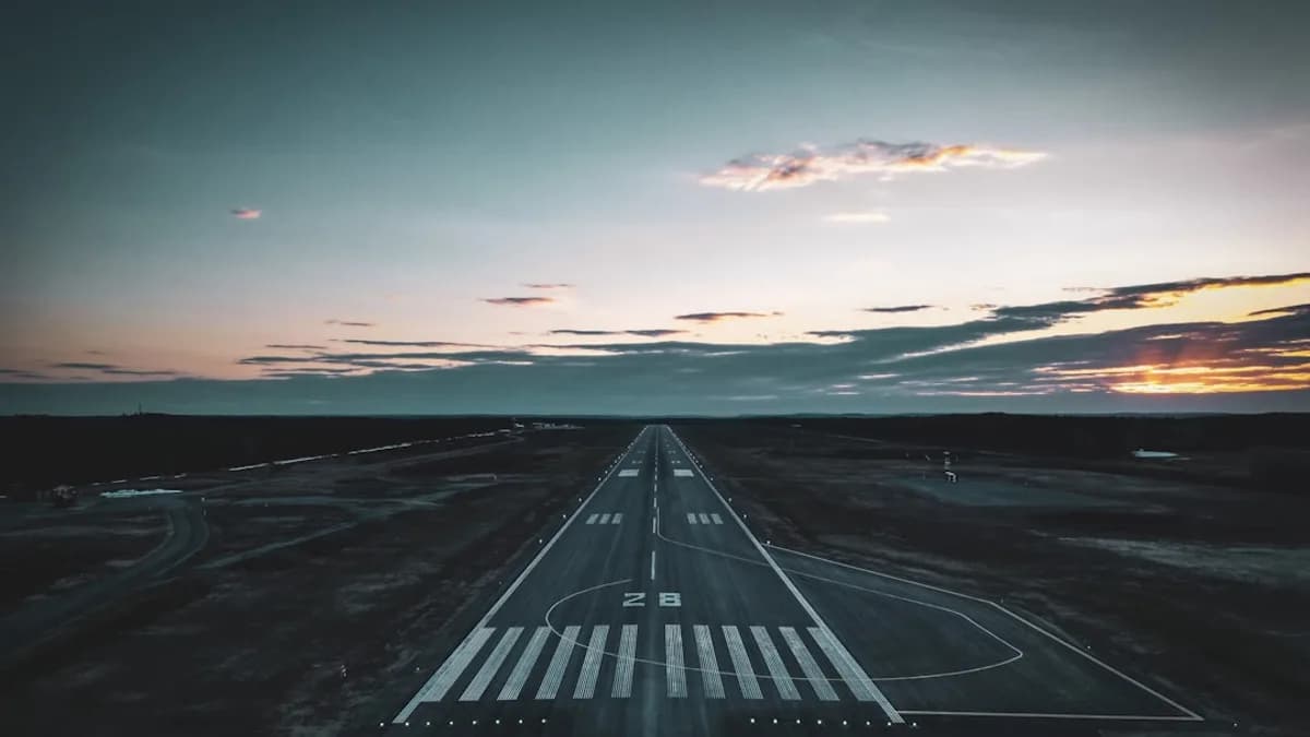 an aerial view of an airport runway at sunset