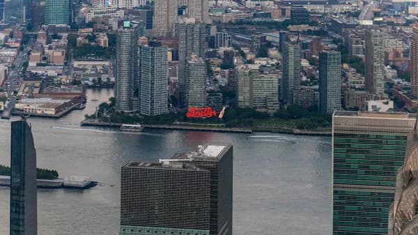 Aerial view of a city skyline with skyscrapers and river.
