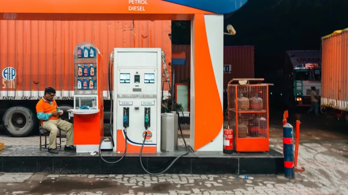 Man sitting at a petrol station at night