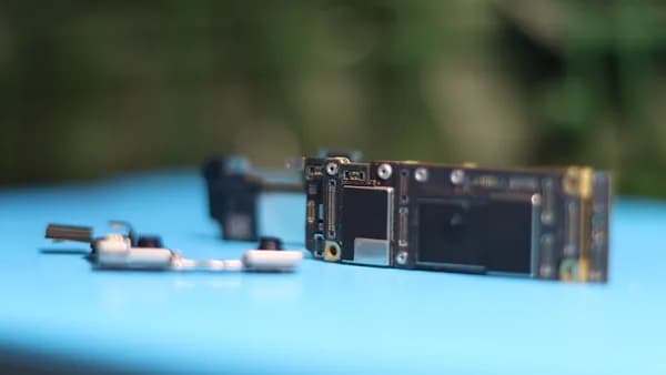 Phone components are placed on a blue surface.