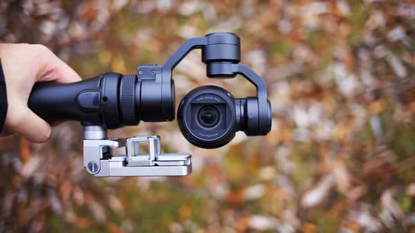 person holding black tripod with camera