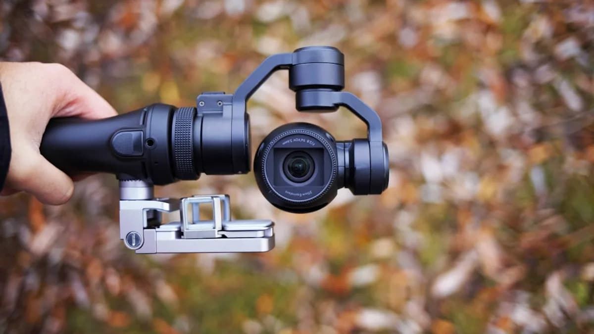 person holding black tripod with camera