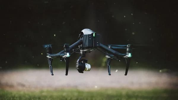 selective focus photography of black and gray quadcopter drone taking flight