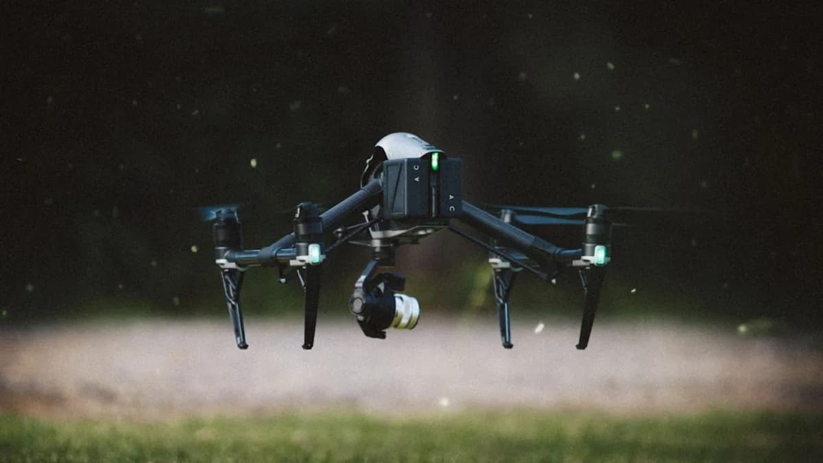 selective focus photography of black and gray quadcopter drone taking flight