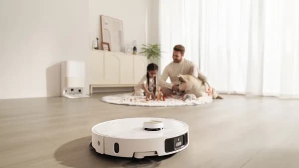 Robot vacuum cleans floor while family relaxes
