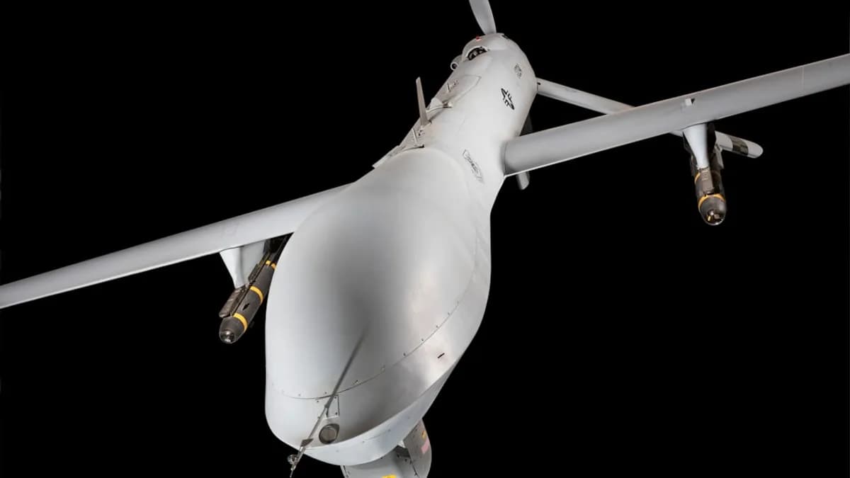 A military drone with missiles flies against a black background.
