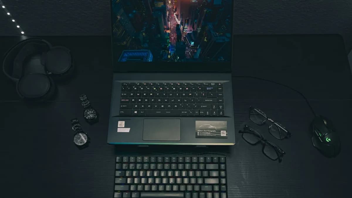 a laptop computer sitting on top of a wooden desk