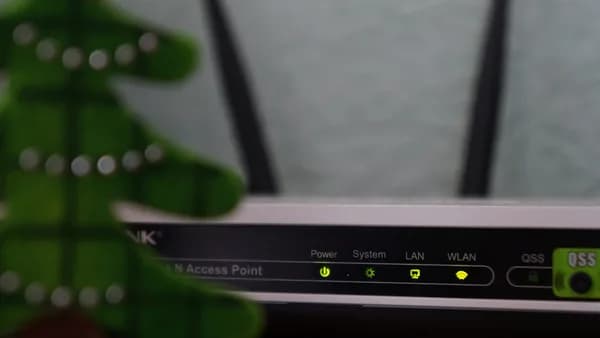white and black modem router with four lights