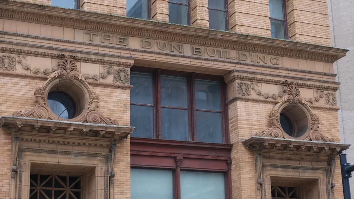 The dun building is displayed on the brick structure.