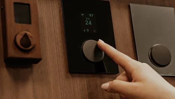 a hand holding a black device