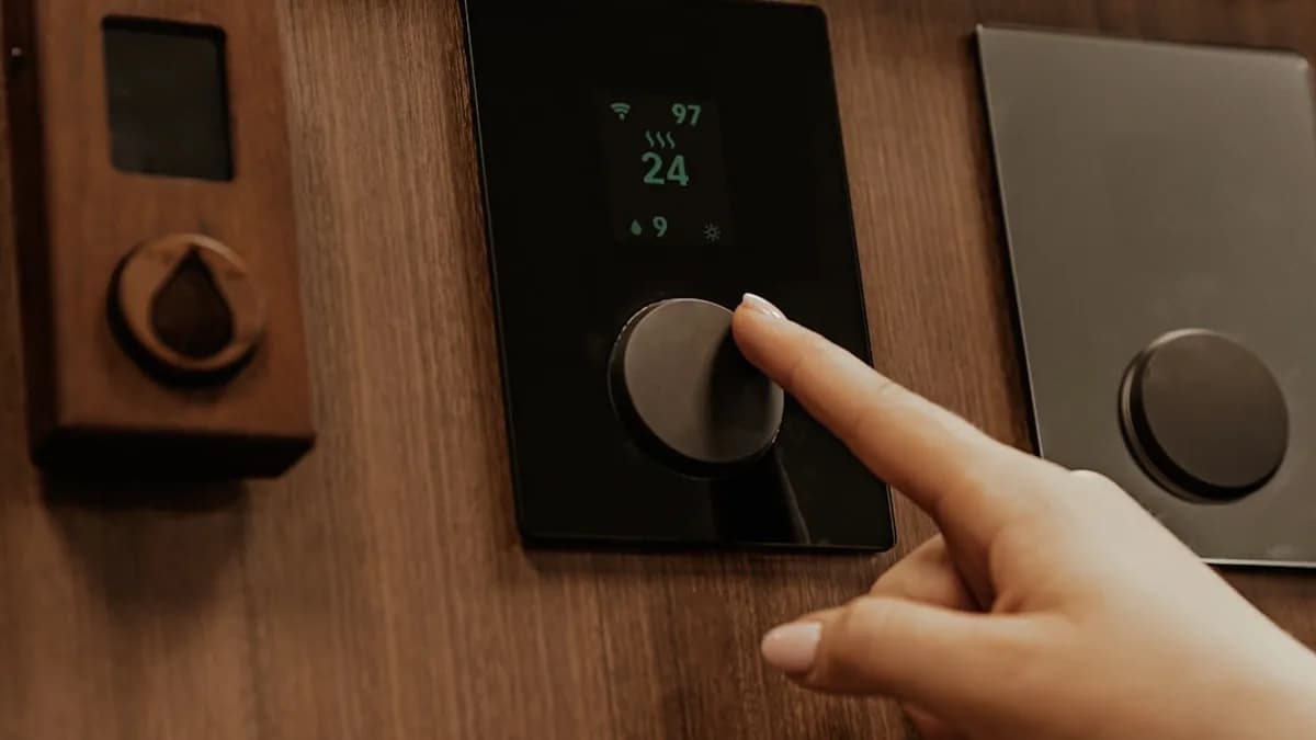 a hand holding a black device