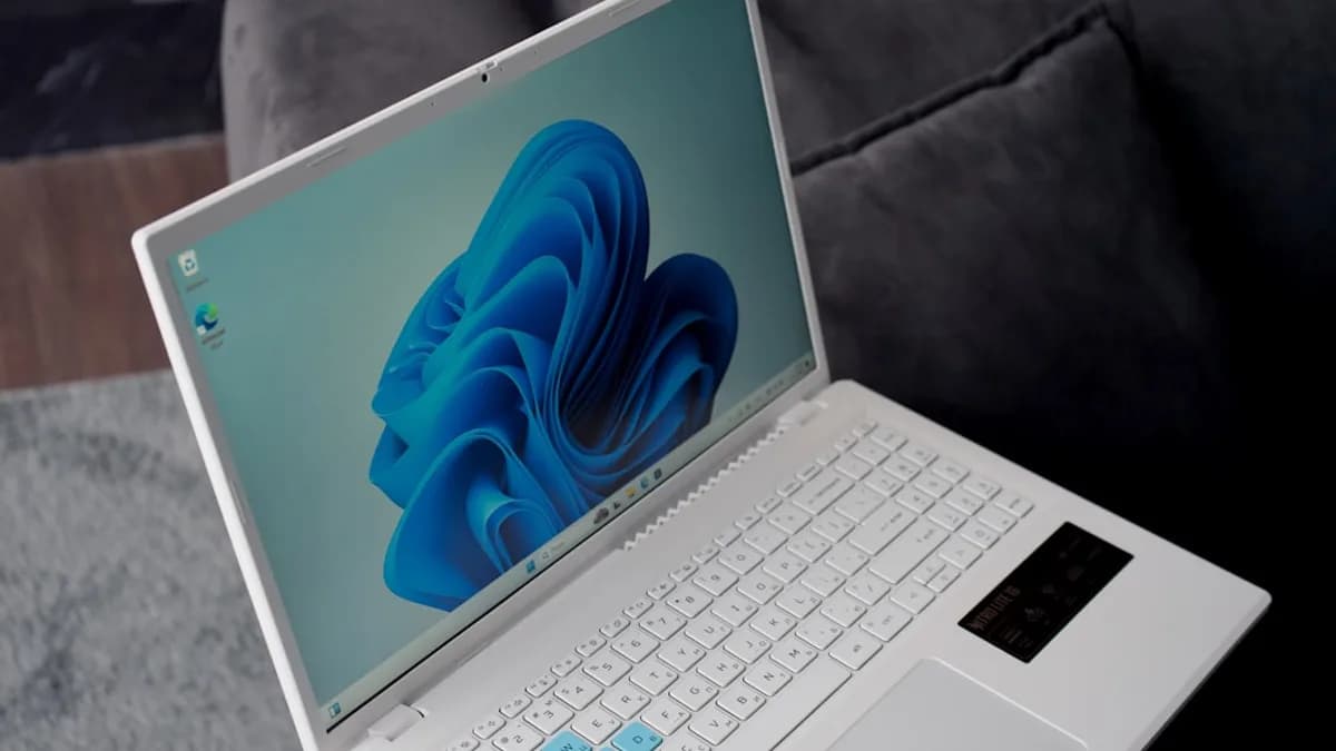 A white laptop with a blue windows 11 wallpaper.