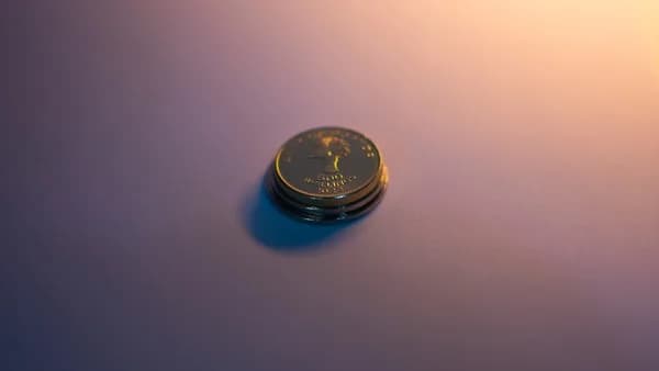 A stack of coins reflects light.