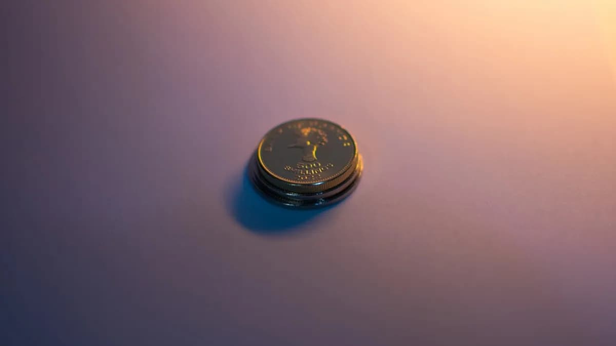 A stack of coins reflects light.