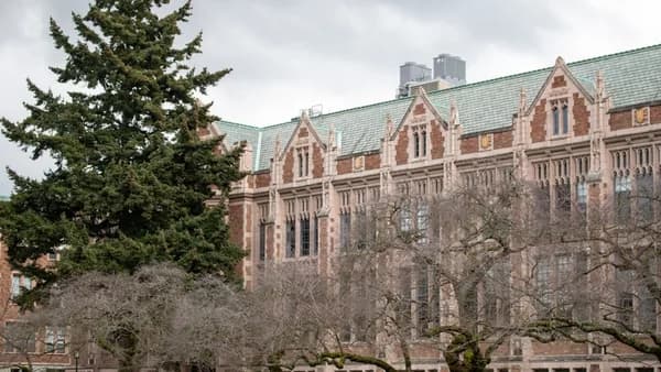 A university building sits beneath a cloudy sky.