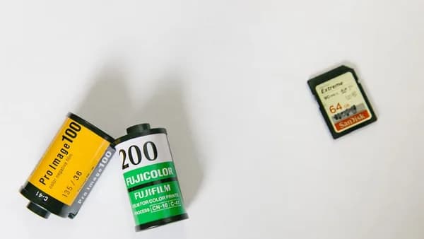 SanDisk adapter near two film cases