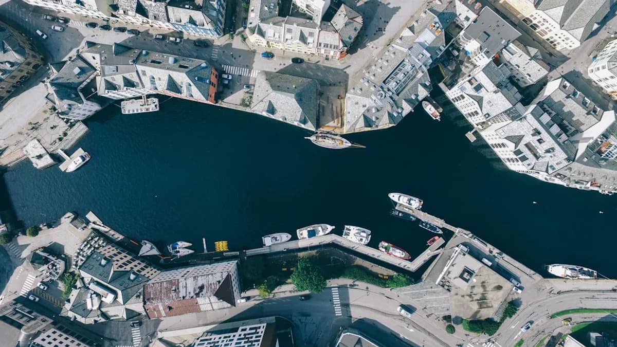 aerial photography of river in the middle of concrete buildings