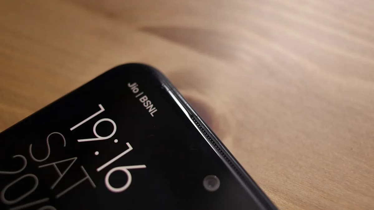 a cell phone sitting on top of a wooden table