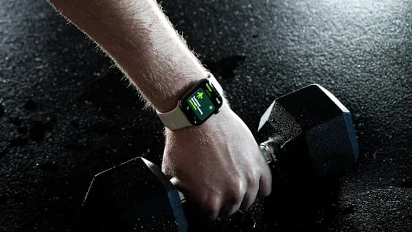 a person's hand holding a watch
