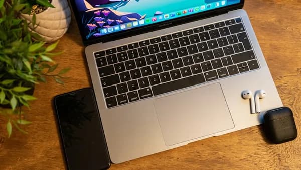 macbook pro on brown wooden table
