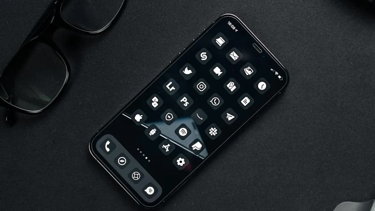 black remote control beside black framed eyeglasses