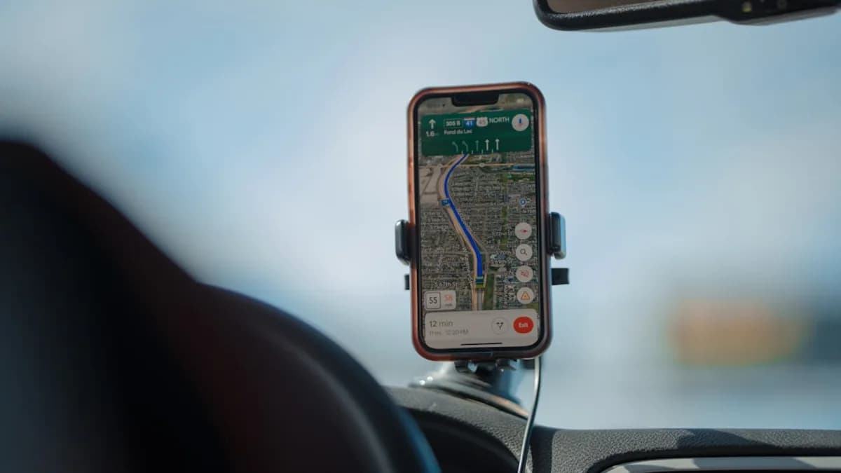 Smartphone navigation app displaying a route on car dashboard