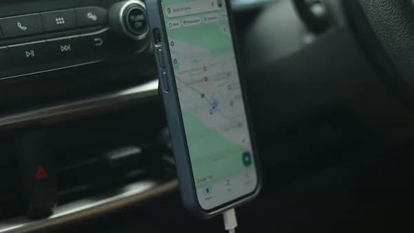Smartphone with navigation app mounted in car