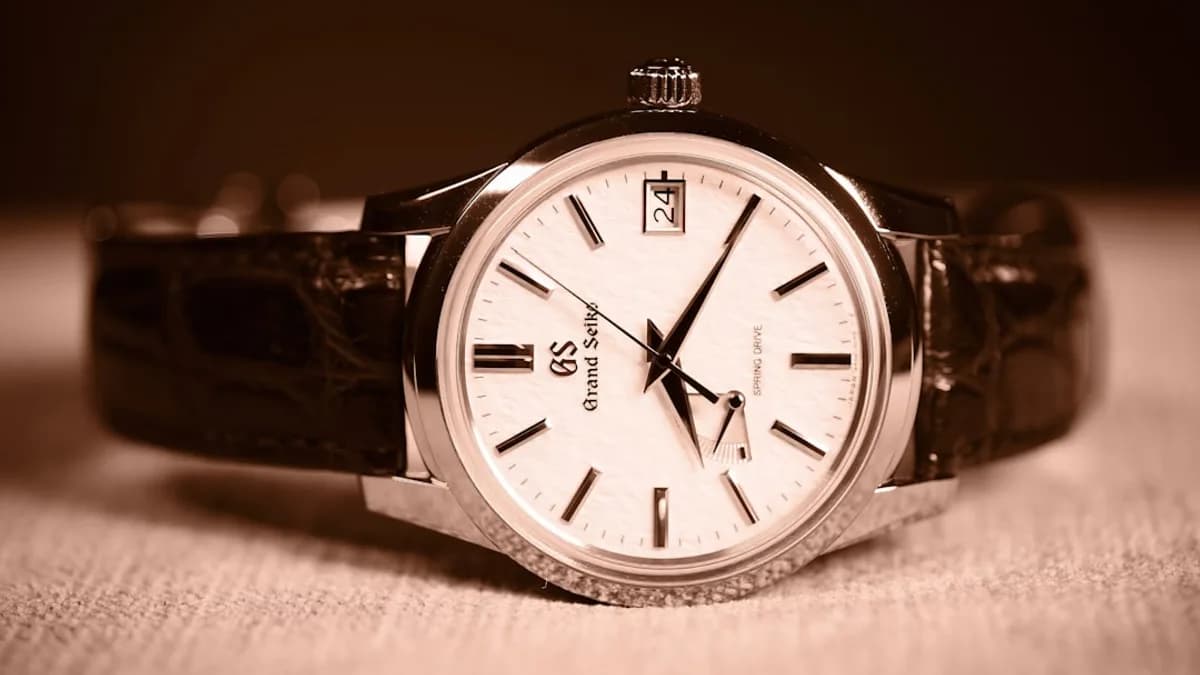 A watch sitting on top of a wooden table