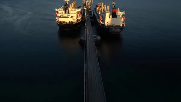 two large ships in the middle of a body of water