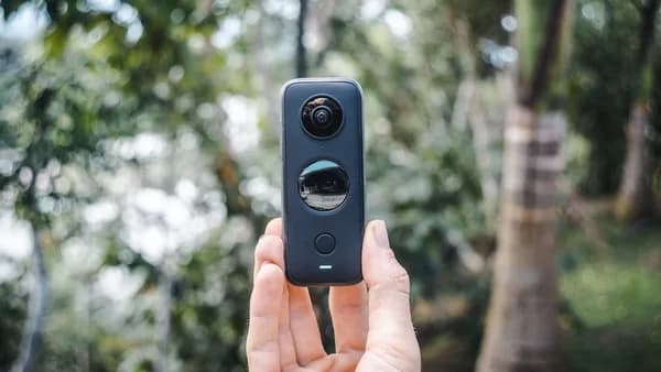 person holding black and gray camera
