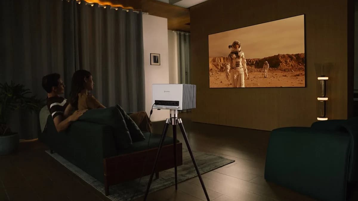 Couple watches movie projected onto wall