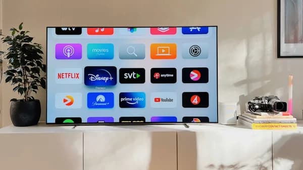 a flat screen tv sitting on top of a white cabinet