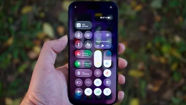 Hand holding a smartphone with colorful app icons.