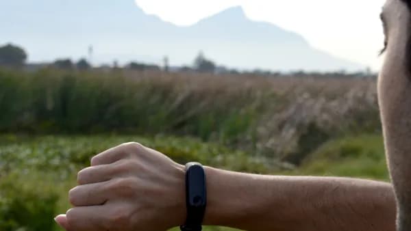 man looking at black fitness tracker