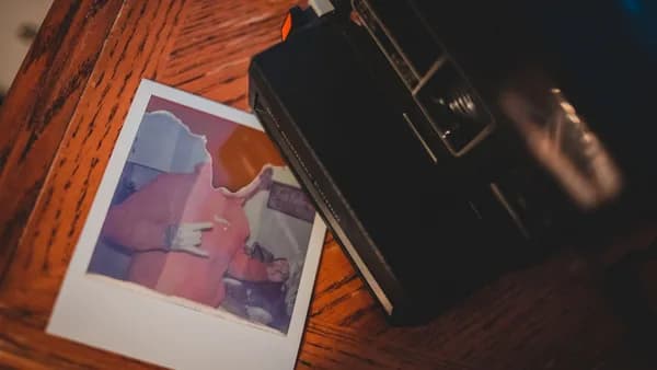 black camera on brown wooden table