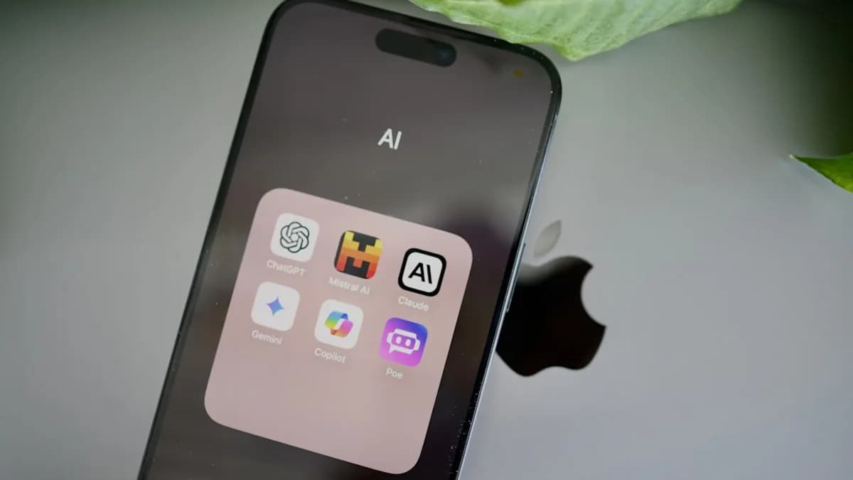 an iphone sitting on top of a table next to a leaf