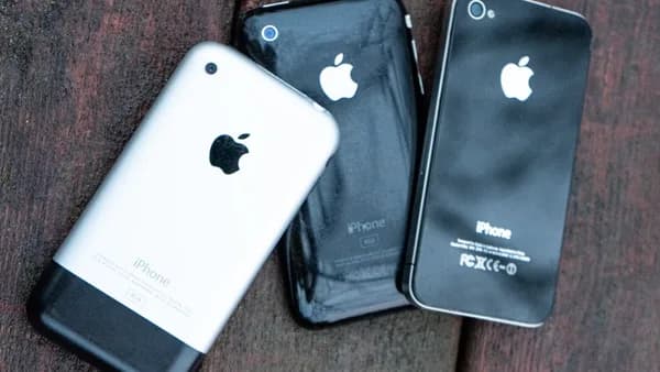 two iphones sitting next to each other on a wooden surface