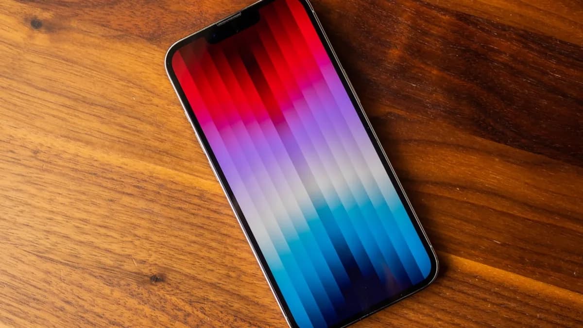 an iphone on a wooden table with a blurry background