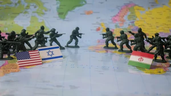 Toy soldiers face off with flags on world map